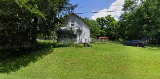 Older residential home with mature trees, the kind of inherited property commonly found in probate lead lists