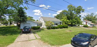 Two-story residential home on a quiet street, the type of property typically found in off-market lead lists